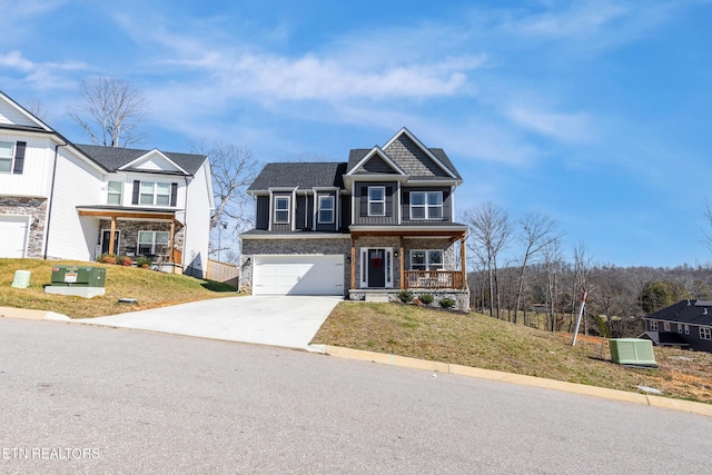 view of front of home with a porch, a front lawn, and a garage