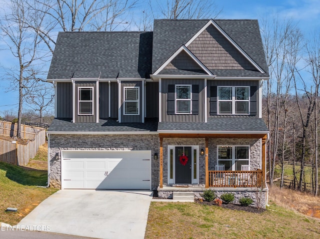 craftsman inspired home with a front lawn, a garage, and a porch