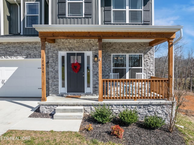 view of exterior entry with a porch