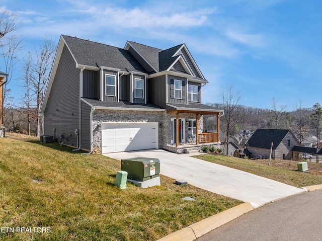 view of front of property with a front yard, central AC, a garage, and a porch