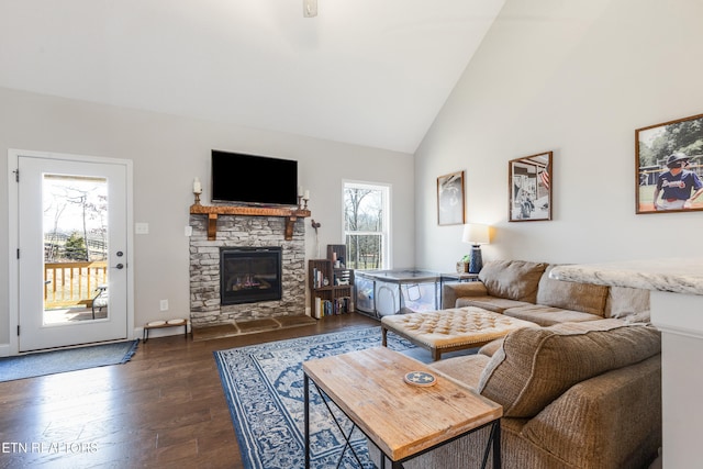 living room with dark wood-type flooring, a fireplace, and high vaulted ceiling