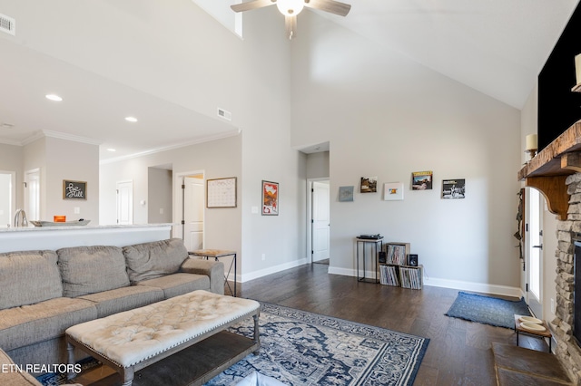 living room with dark hardwood / wood-style flooring, ceiling fan, a fireplace, and ornamental molding