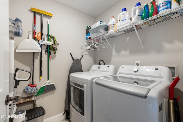 clothes washing area with washing machine and dryer