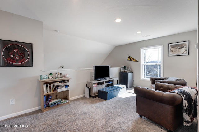 carpeted living room with vaulted ceiling