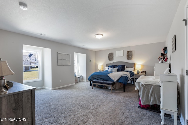 bedroom featuring a textured ceiling and carpet