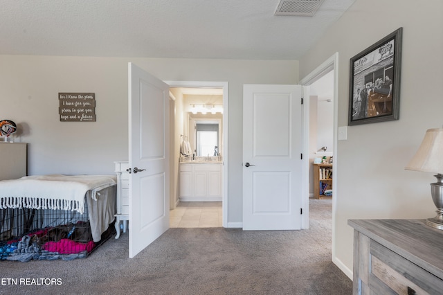 carpeted bedroom featuring a textured ceiling