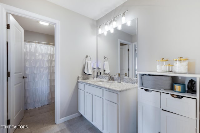 bathroom featuring tile patterned flooring and vanity