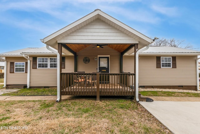 bungalow with a front yard, crawl space, ceiling fan, metal roof, and a wooden deck