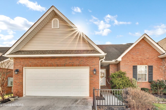 view of front of home featuring an attached garage, brick siding, driveway, and roof with shingles