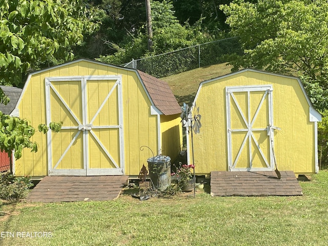view of shed featuring fence