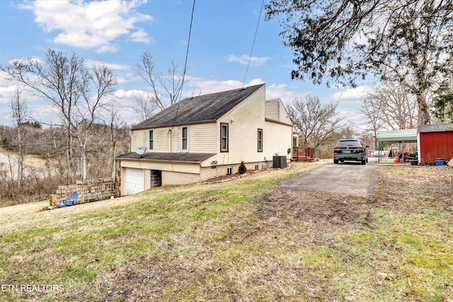 view of home's exterior with a yard and central AC unit