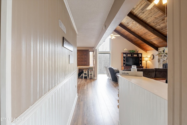 corridor with vaulted ceiling with beams, wood-type flooring, wood ceiling, and visible vents