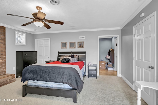 carpeted bedroom with baseboards, visible vents, a ceiling fan, and ornamental molding