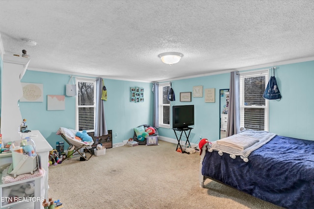 carpeted bedroom featuring ornamental molding, a textured ceiling, and baseboards