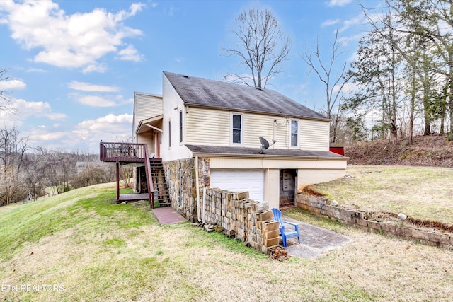 view of front facade featuring a garage, stairs, stone siding, a wooden deck, and a front yard