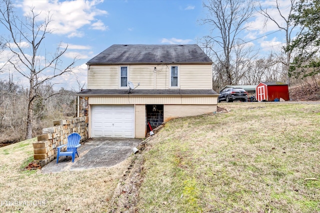 rear view of house with an outbuilding, an attached garage, a yard, driveway, and a shed