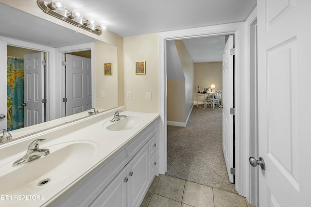 full bathroom featuring double vanity, baseboards, a sink, and tile patterned floors