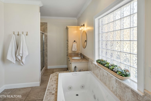 full bath featuring baseboards, tile patterned floors, a jetted tub, crown molding, and vanity