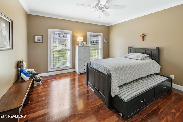 bedroom featuring ornamental molding, dark wood finished floors, baseboards, and ceiling fan