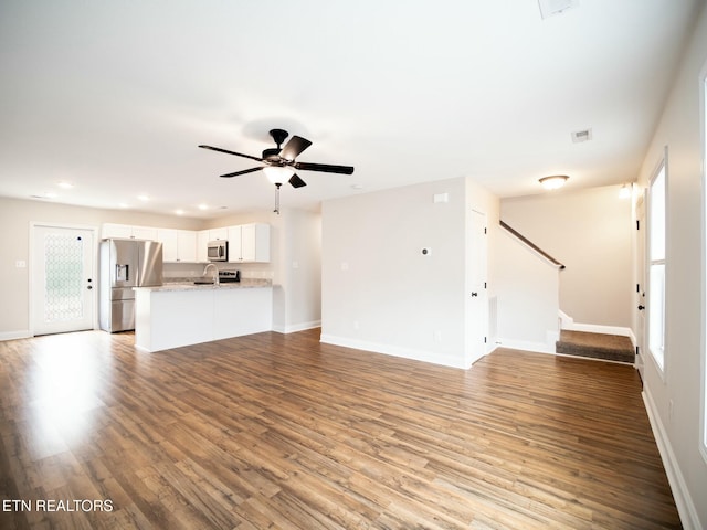 unfurnished living room with ceiling fan, a healthy amount of sunlight, and light hardwood / wood-style flooring