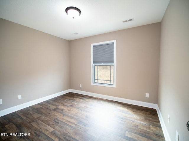 empty room with dark hardwood / wood-style floors