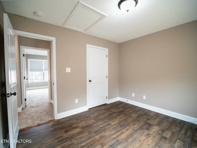 unfurnished bedroom featuring dark hardwood / wood-style floors