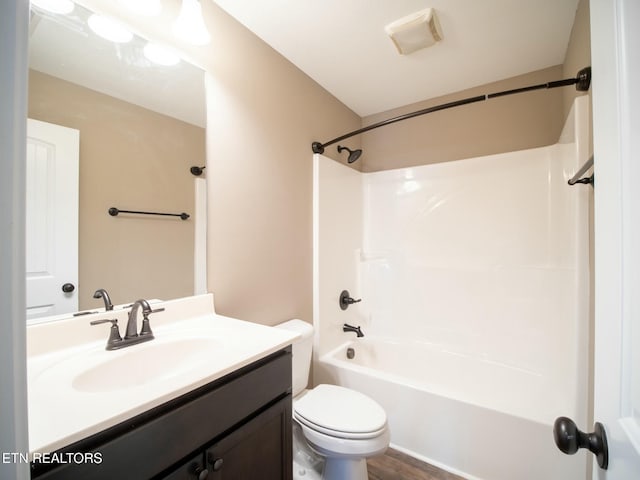 full bathroom featuring toilet, vanity, and tub / shower combination