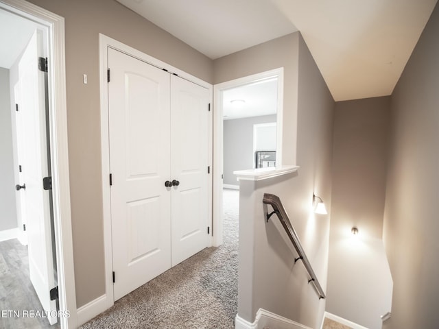 hallway with light colored carpet