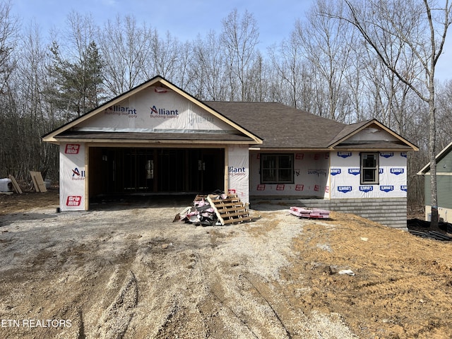 property under construction with driveway and a garage