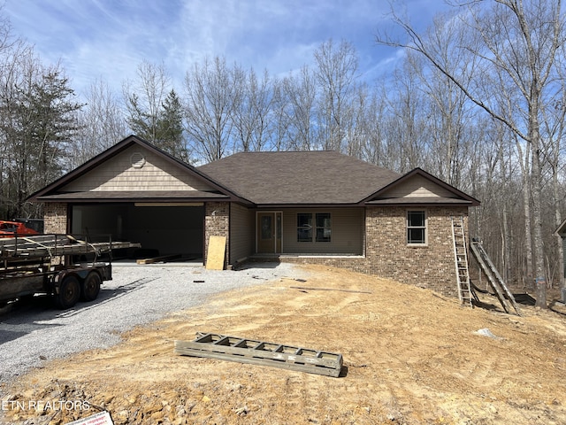 180 Hawes Cir, Crossville, TN 38558 - single story home with a garage, brick siding, roof with shingles, and driveway