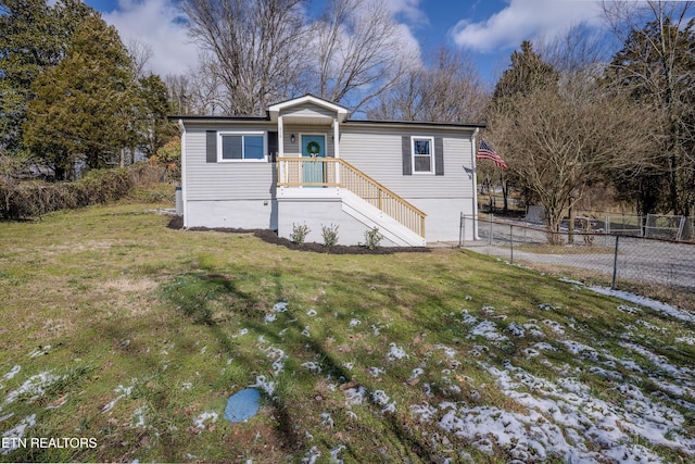 view of front of property with a front yard and fence