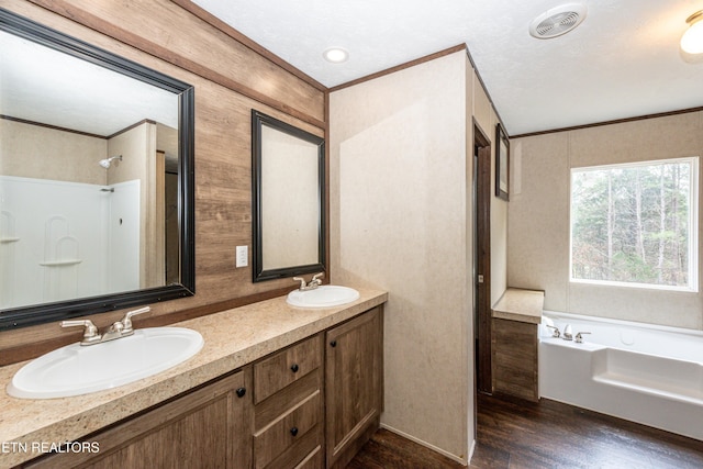 bathroom with a tub, crown molding, and wood-type flooring