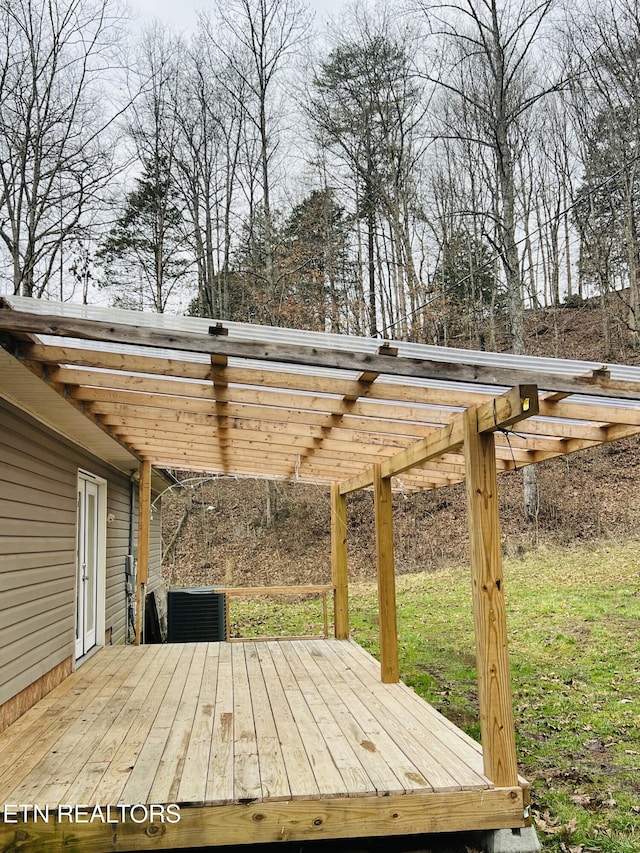 wooden deck with a pergola and a lawn