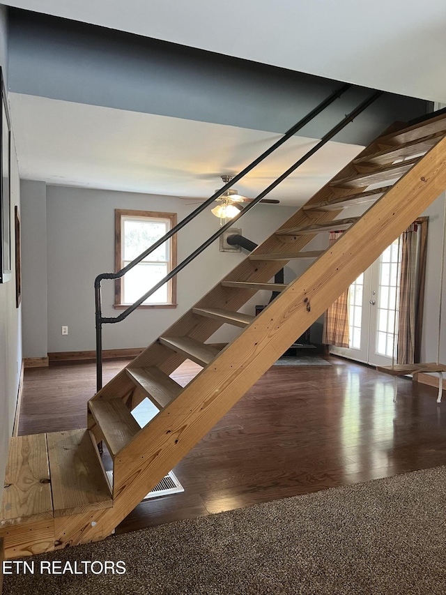 interior space featuring baseboards and wood finished floors