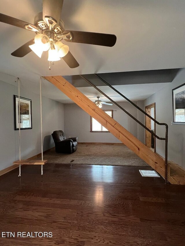 bonus room with a ceiling fan, wood finished floors, and stairway
