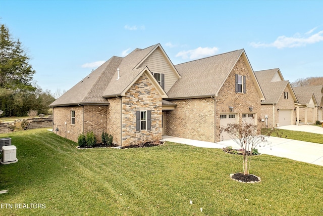 view of front of house with driveway, a shingled roof, a garage, and a front yard