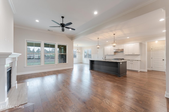 282 Chimney Rock Dr, Lenoir City, TN 37771 - unfurnished living room with a fireplace, wood finished floors, baseboards, ceiling fan with notable chandelier, and ornamental molding
