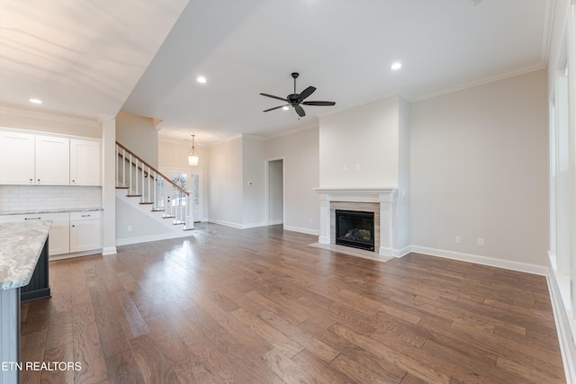 282 Chimney Rock Dr, Lenoir City, TN 37771 - unfurnished living room featuring baseboards, ceiling fan, ornamental molding, stairway, and dark wood-style floors
