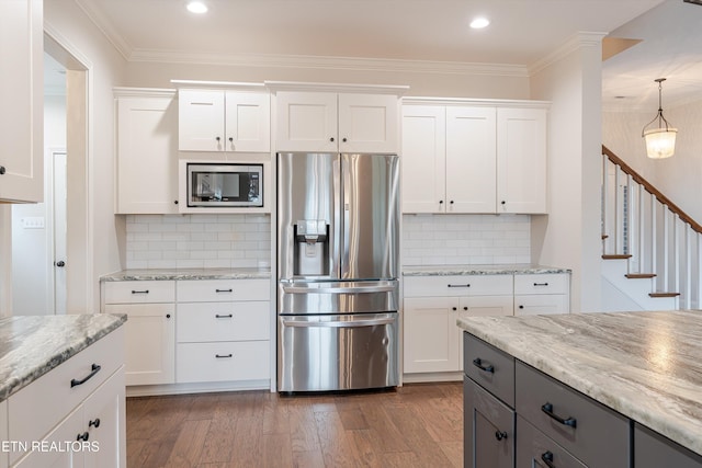282 Chimney Rock Dr, Lenoir City, TN 37771 - kitchen with white cabinetry, ornamental molding, dark wood finished floors, light stone countertops, and appliances with stainless steel finishes