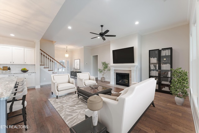 282 Chimney Rock Dr, Lenoir City, TN 37771 - living area featuring a fireplace, ornamental molding, dark wood-type flooring, and stairs