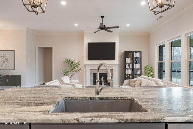 282 Chimney Rock Dr, Lenoir City, TN 37771 - kitchen with open floor plan, a sink, crown molding, and light stone countertops