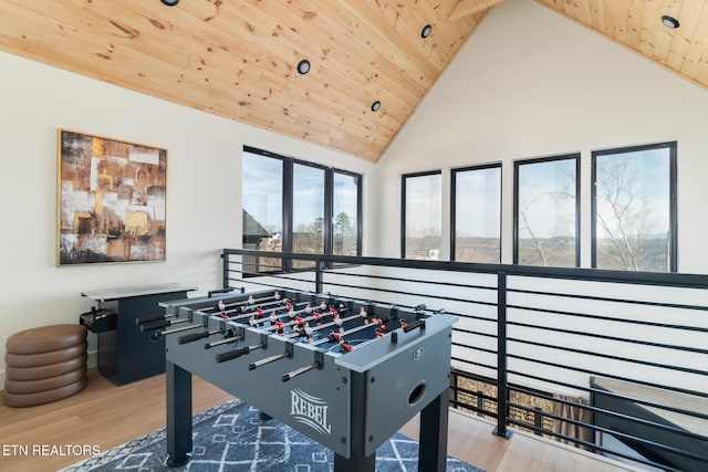 playroom with high vaulted ceiling, light wood-type flooring, and wooden ceiling