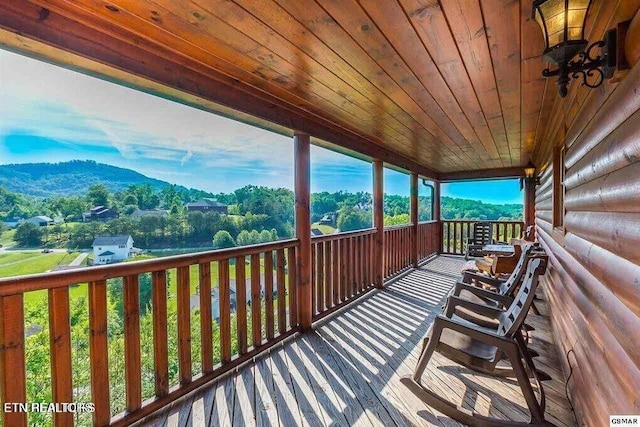 sunroom / solarium with wood ceiling and a mountain view