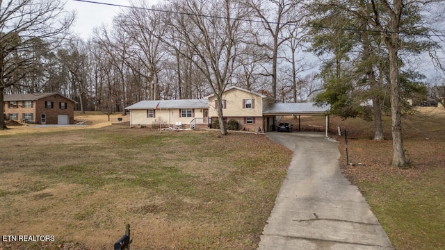 split level home with a front lawn and a carport