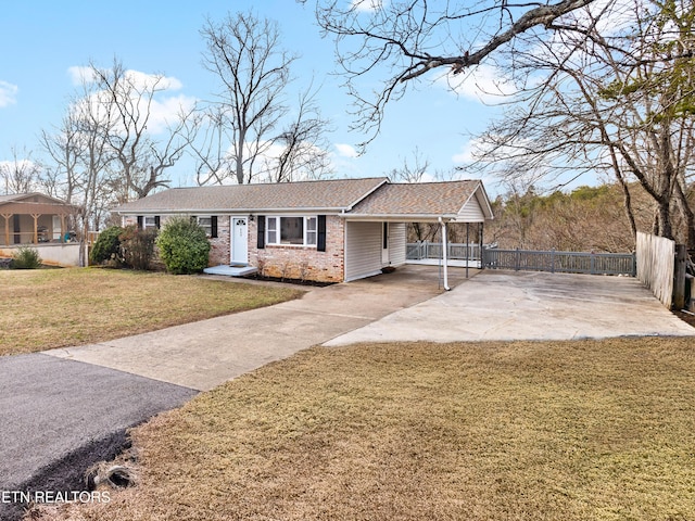 ranch-style home featuring a carport and a front yard