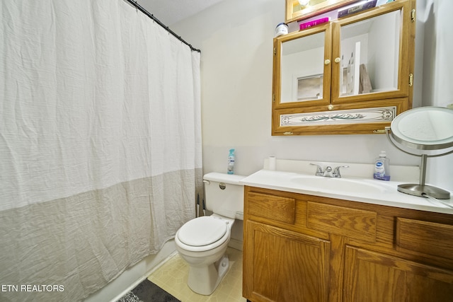 bathroom featuring tile patterned flooring, vanity, and toilet