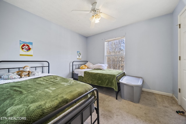 bedroom with light carpet, baseboards, and a ceiling fan