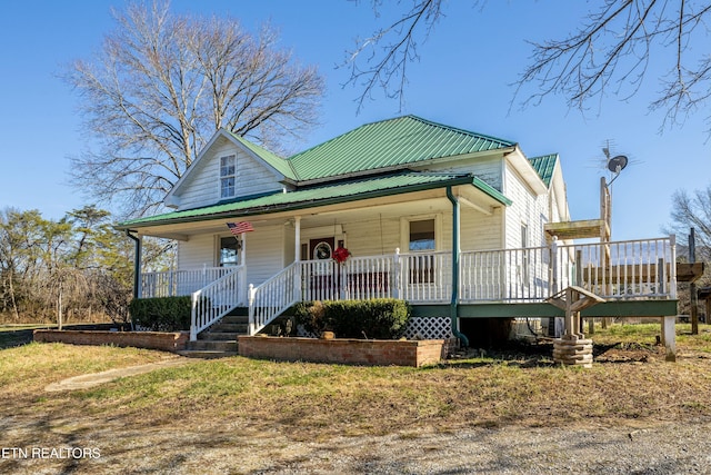 view of front of home featuring covered porch and metal roof