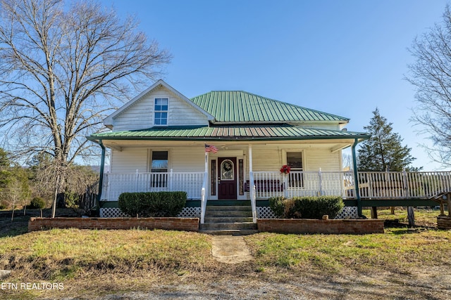 view of front of home featuring covered porch and metal roof