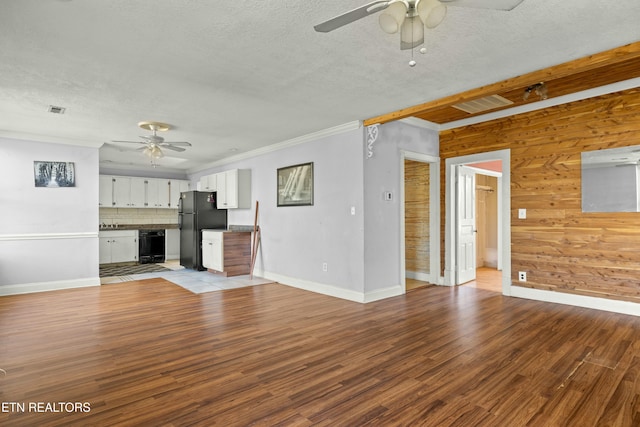 unfurnished living room with ceiling fan, a textured ceiling, visible vents, light wood-type flooring, and crown molding